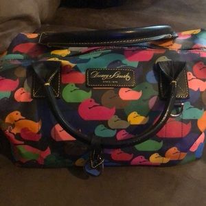This is a Dooney and Bourke satchel black with ducks on it.